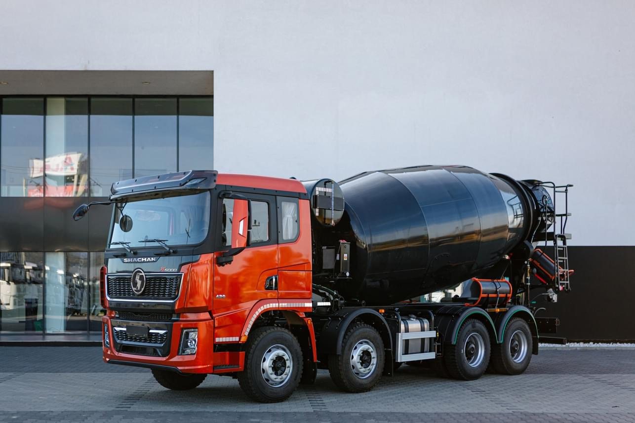 Red SHACMAN X3000 8x4 concrete mixer truck with black mixing drum