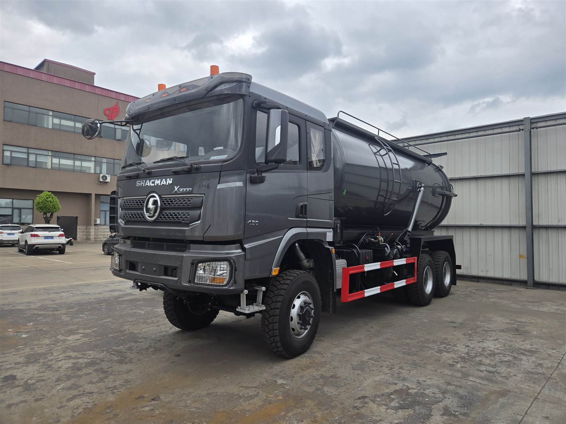 Front-left view of a gray SHACMAN X3000 6x6 vacuum sewage suction truck and cylindrical tank