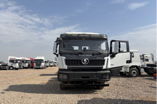 Front view of a white SHACMAN X5000 low-roof tractor with construction-style bumper
