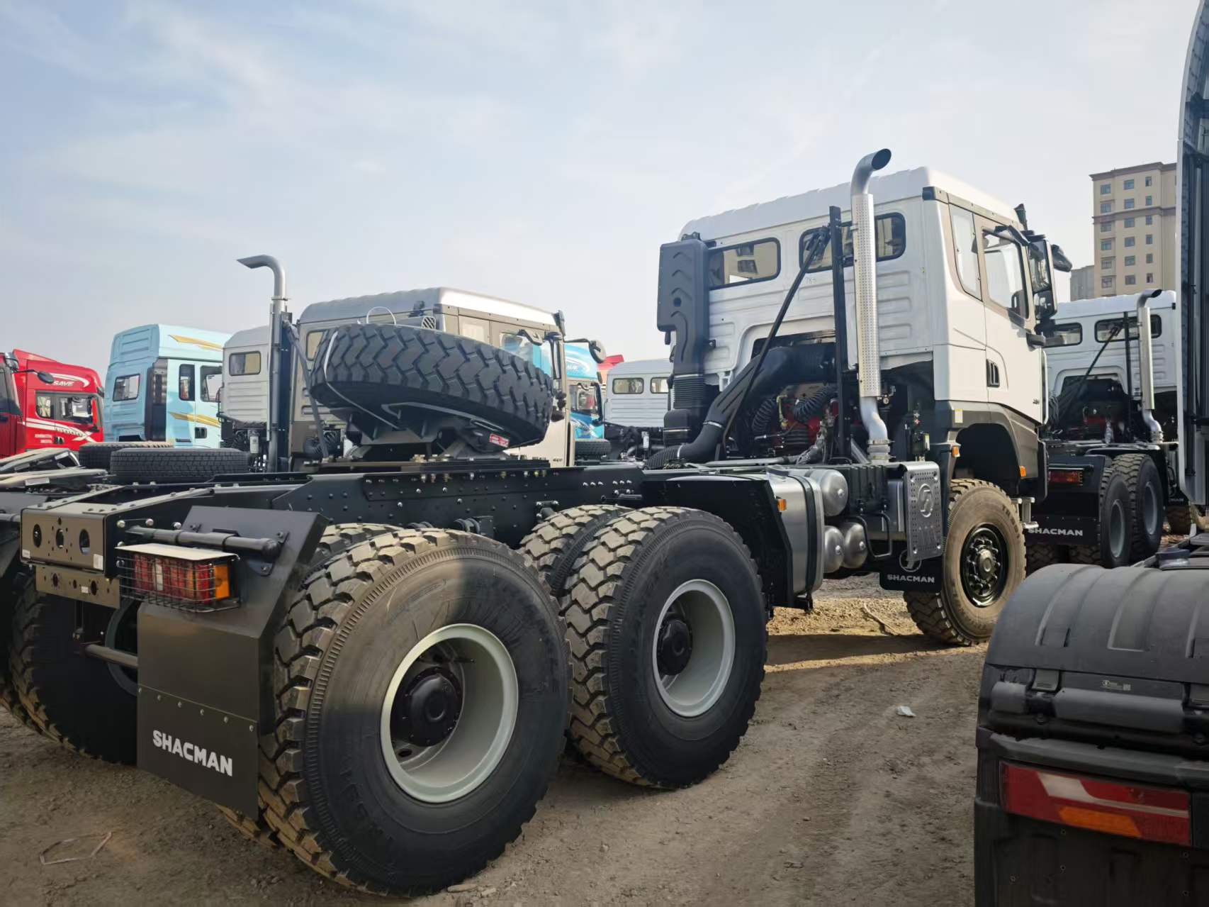 Rear-right view of SHACMAN X3000 6x6 tractor tandem axles, chassis and spare wheel
