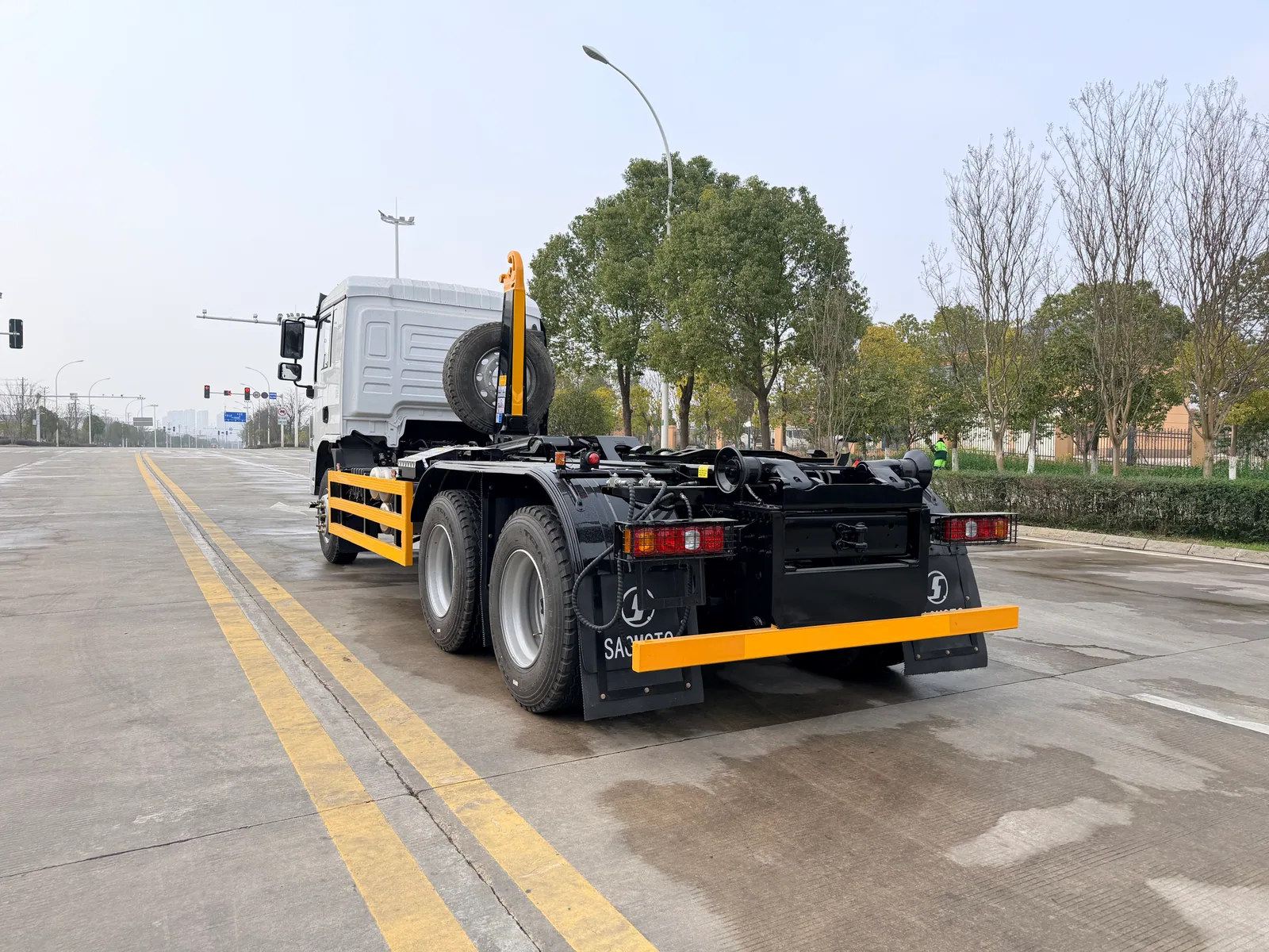 Rear three-quarter view of a SAGMOTO X5s 6x4 hook-lift refuse truck chassis