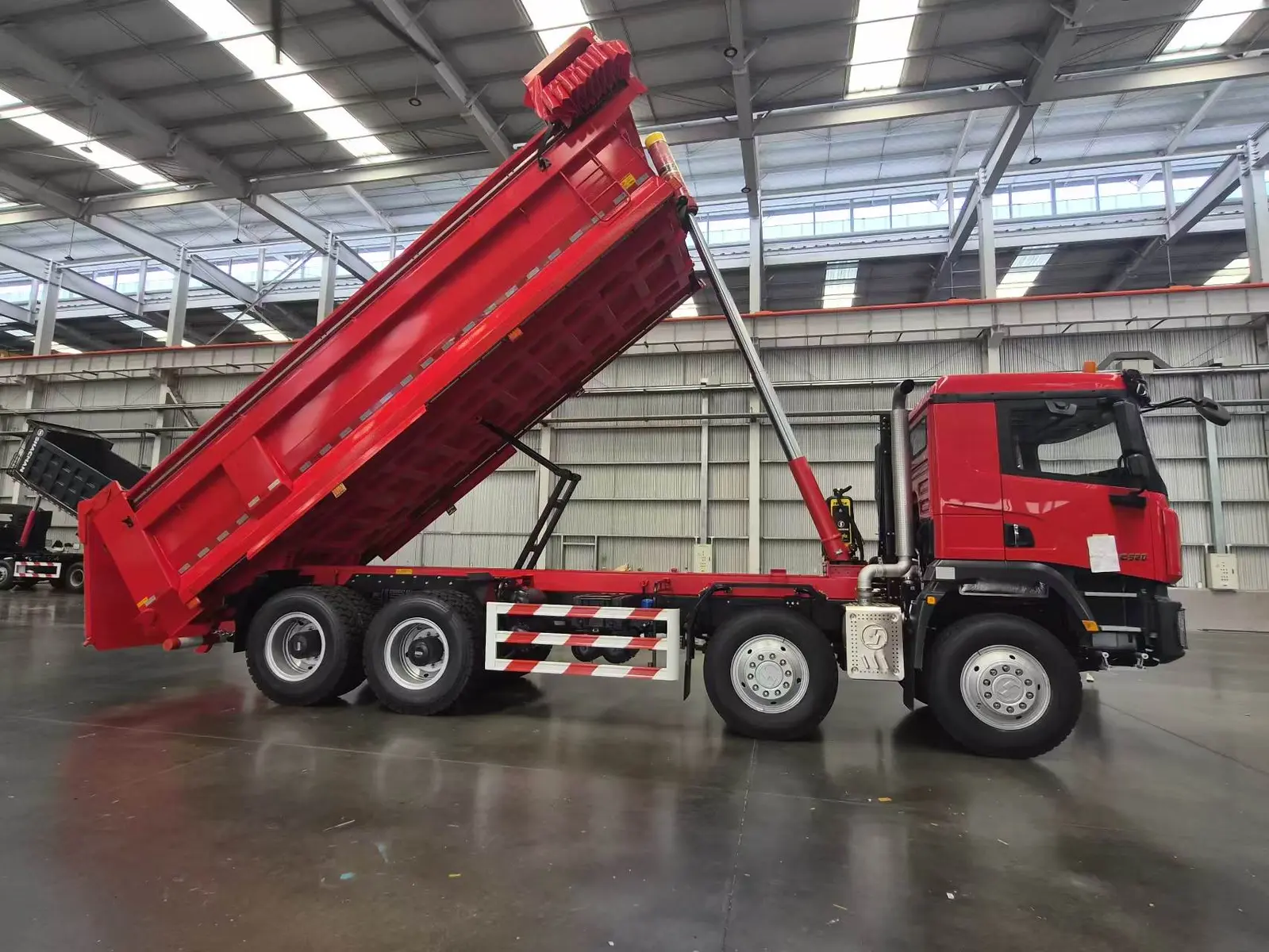 Camión volquete SAGMOTO X1S 8x4 rojo de 520 HP con caja elevada