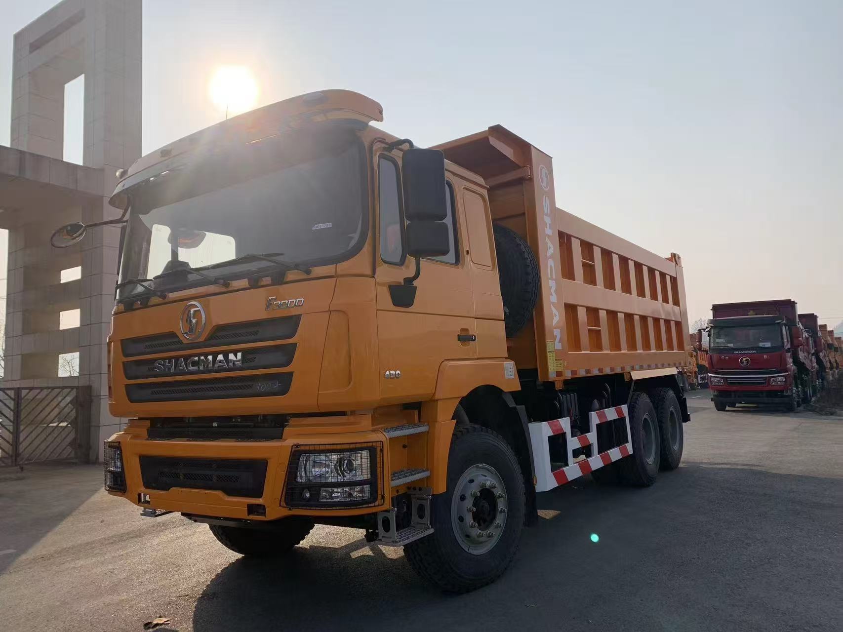Orange SHACMAN F3000 6x4 dump truck, front-left view